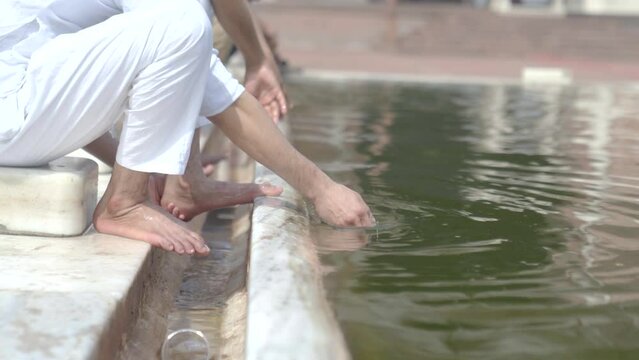 Muslim men doing ghusl or wuzu at Jama masjid Delhi before prayer