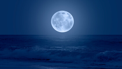 Super Full Moon. Colorful sky with cloud and bright full moon over seascape "Elements of this image furnished by NASA"