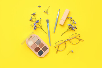 Female accessories with flowers on yellow background
