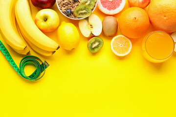 Fruits, oatmeal flakes and green measuring tape on yellow background. Diet concept