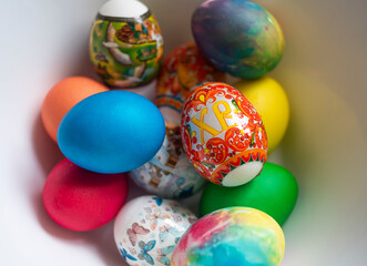 Fototapeta na wymiar A bowl of colorful easter eggs with the letter x on it