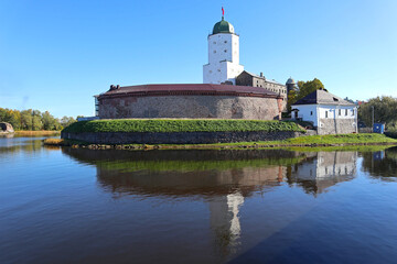Plakat Old castle in the city of Vyborg, Russia. Cityscape with ancient fortress on island is popular tourist destination and historic building landmark.