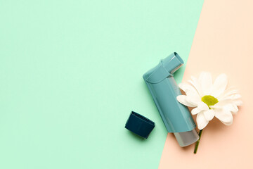 Asthma inhaler with daisy flower on color background