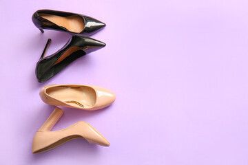Fashionable high heeled shoes on lilac background