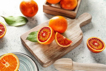 Board with slices of juicy blood orange fruit on white table