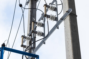 High voltage power line details mounted on a concrete pole