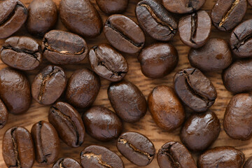 Coffee beans isolated on wooden background.