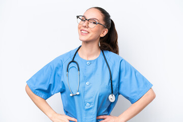 Young caucasian surgeon doctor woman isolated on white background posing with arms at hip and smiling