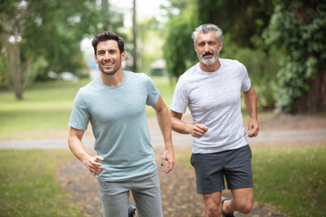 men or male friends running outdoors