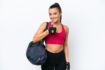 Naklejka premium Young sport woman with sport bag isolated on white background giving a thumbs up gesture
