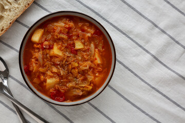 Homemade Shredded Cabbage and Potato Soup in a Bowl, top view. Overhead, from above, flat lay.