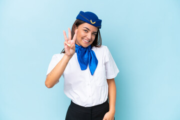 Airplane stewardess caucasian woman isolated on blue background happy and counting three with fingers