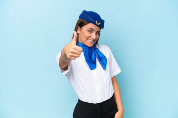 Airplane stewardess caucasian woman isolated on blue background with thumbs up because something good has happened