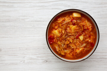Homemade Shredded Cabbage and Potato Soup in a Bowl, top view. Overhead, from above, flat lay. Copy space.