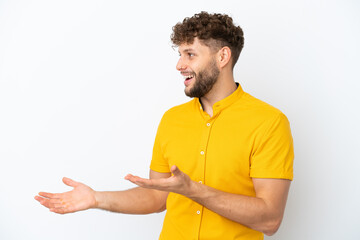 Young handsome caucasian man isolated on white background with surprise expression while looking side