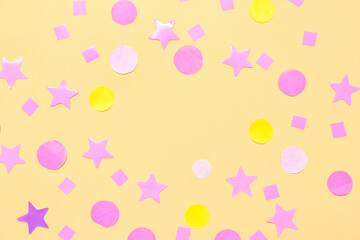 Frame made of confetti and stars on yellow background