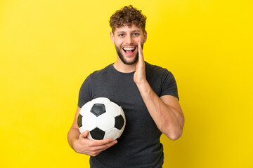 Handsome young football player man isolated on yellow background with surprise and shocked facial expression