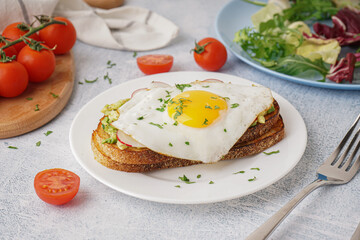 Delicious sandwich with fried egg on grunge background