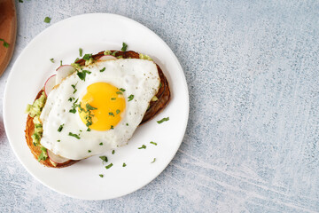 Delicious sandwich with fried egg on grunge background
