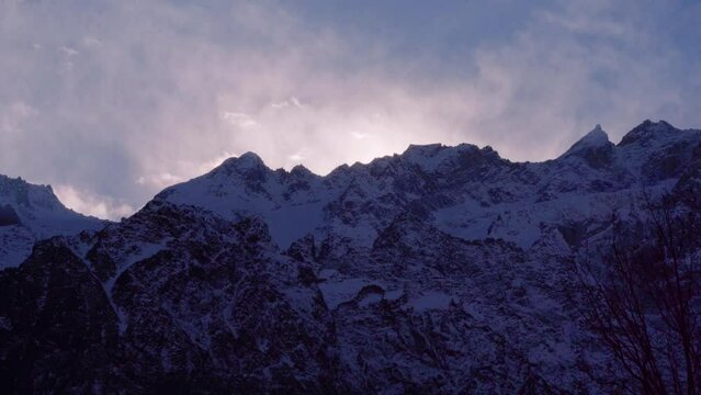monsoon clouds moving over snow covered mountains near shimla kullu manali showing the serene sunrises in the himalaya mountains