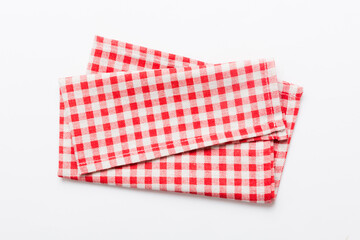 top view with red empty kitchen napkin isolated on table background. Folded cloth for mockup with copy space, Flat lay. Minimal style