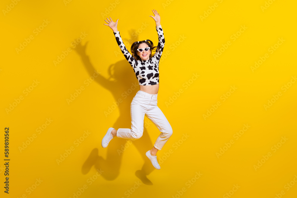 Wall mural Full size photo of youth lady jumping enjoy her cowgirl look wearing black spotted clothes isolated shine color background