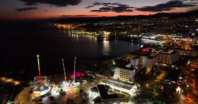 Aerial footage of the promenade in Eilat with the beautiful hotels in the evening. Shot in C4K Apple ProRes 422 HQ