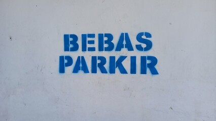 parking free sign printed on white wall