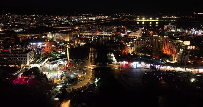 Aerial footage of the promenade in Eilat with the beautiful hotels in the evening. Shot in C4K Apple ProRes 422 HQ