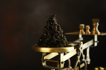 Black caviar on antique scales. A delicacy of sturgeon fish. Brass antique scales. A symbol of wealth and luxurious life. A useful omega. An appetizer for exquisite parties. - obrazy, fototapety, plakaty