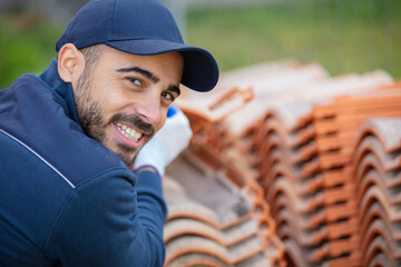 builder working with roof tiles