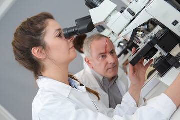 Fototapeta na wymiar observing how the student use the microscope