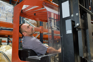 Fototapeta na wymiar man with forklift at a factory