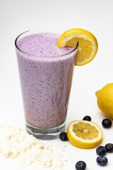 Purple milkshake with lemon in white background