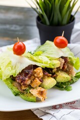 Plate with meat and avocado wrapped in lettuce