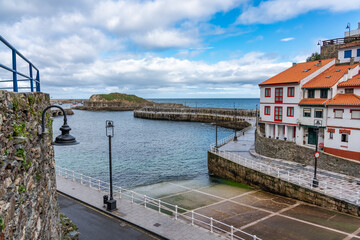 Naklejka premium Entrance to the village from the sea in the fishing village of typical houses of Asturias in Cudillero.