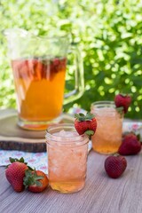 Vertical shot of tasty cold strawberry lemonade on a wooden table