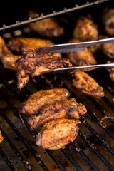 Closeup shot of tasty and homemade grilled chicken on the grill on the blurred background