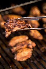 Closeup shot of tasty and homemade grilled chicken on the grill on the blurred background