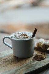 Vertical shot of a cup of hot chocolate on the wooden background