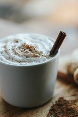 Vertical shot of a cup of hot chocolate on the wooden background