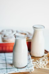Vertical of the fresh milkshake and cinnamon rolls on the put on the wooden table