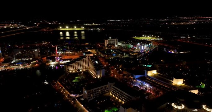 Aerial footage of the promenade in Eilat with the beautiful hotels in the evening. Shot in C4K Apple ProRes 422 HQ