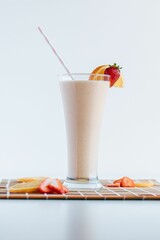 Vertical shot of a strawberry milkshake on the white background