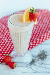 Vertical shot of a strawberry milkshake on the white background