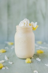 Obraz na płótnie Canvas Vertical closeup shot of a glass of a milkshake surrounded by fruits