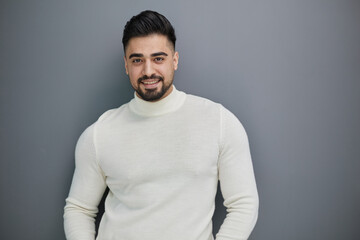 Handsome man in casual sweater looking at camera, positive person.