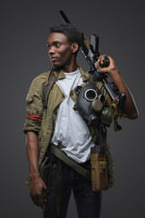 Fototapeta na wymiar Portrait of african man pirate in setting of post apocalypse against gray background.