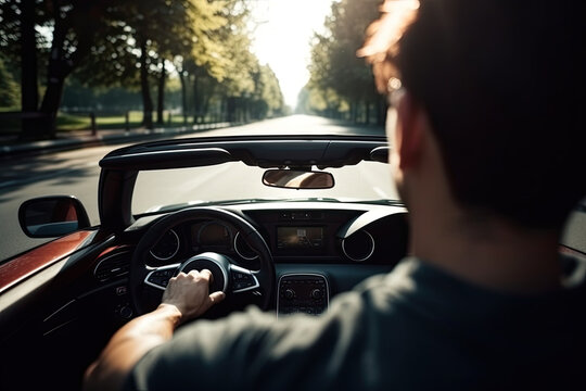 Young man driving in a convertible sports car photo from behind with copy space	