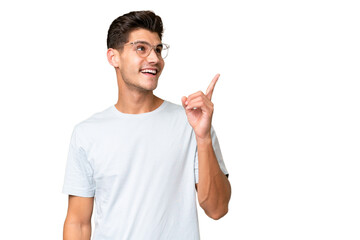 Young caucasian handsome man over isolated background intending to realizes the solution while lifting a finger up